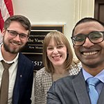 Three people taking a selfie in front of senator's office
