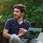 man talking to someone while holding a laptop