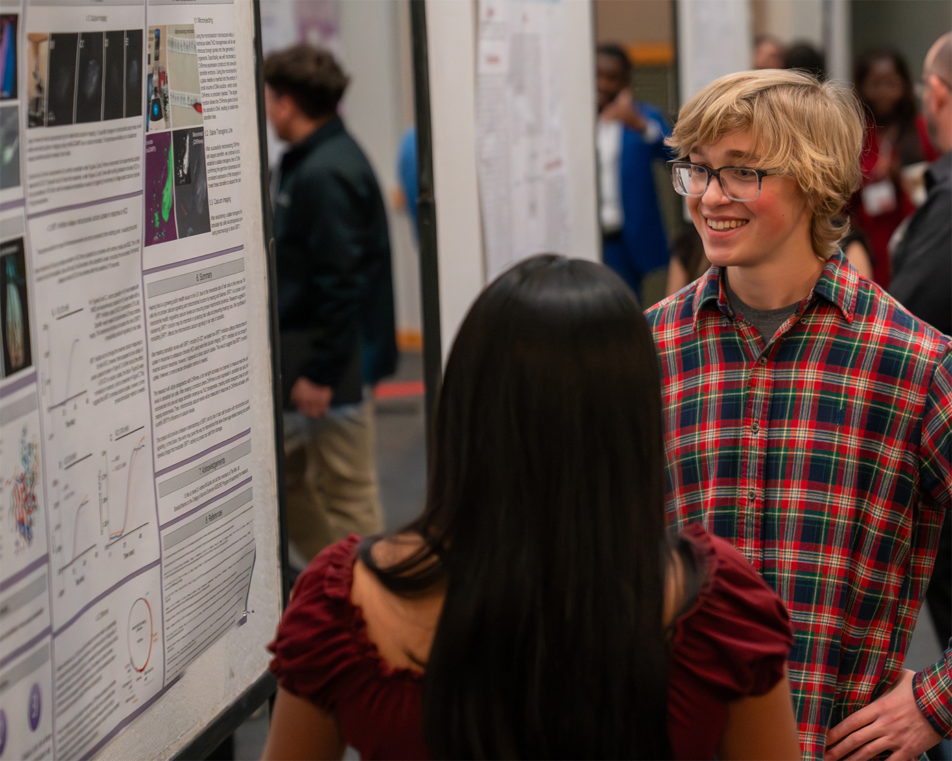 researchers discussing poster a conference